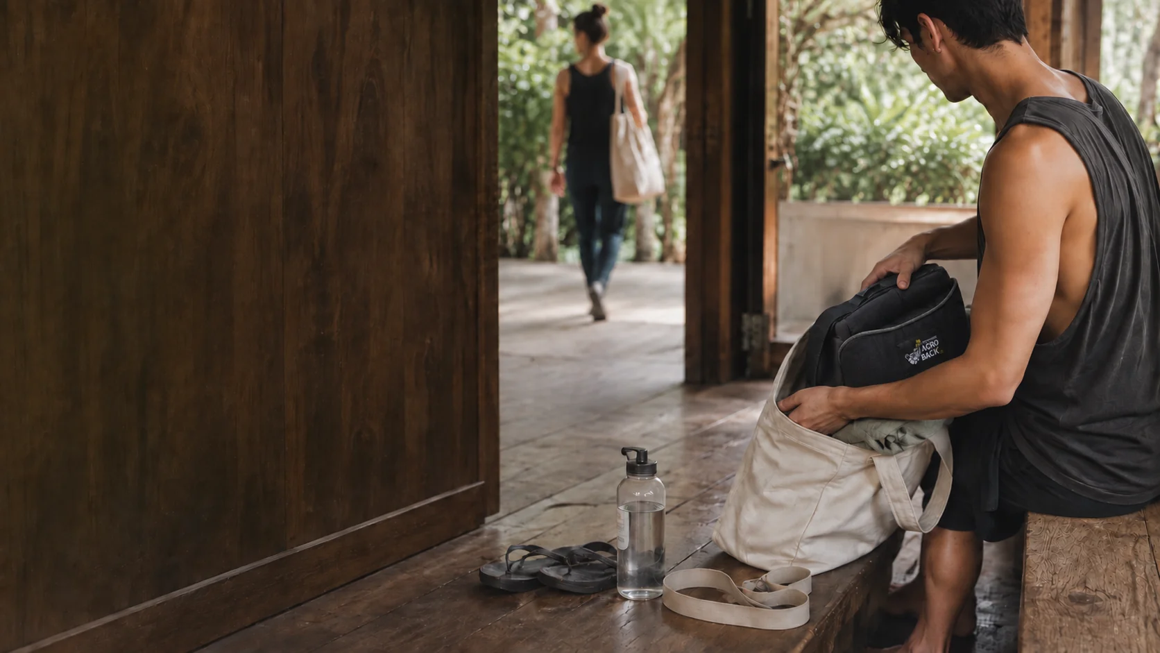 A practitioner packs an Acro Back pillow into a canvas bag.